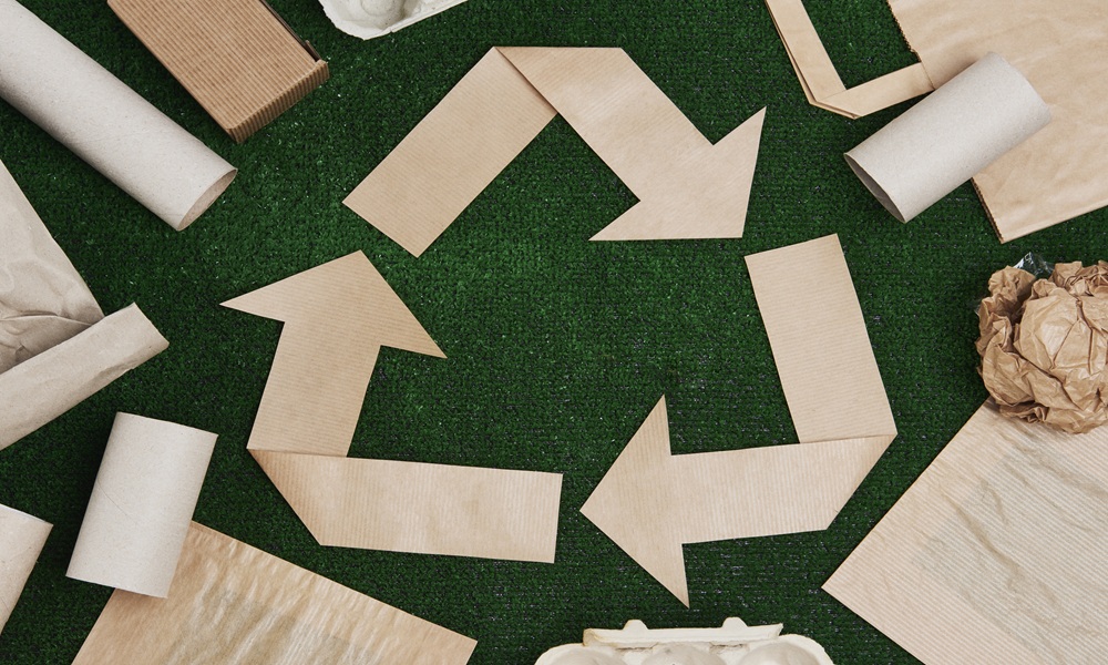 Recycling symbol formed from folded paper strips, construction waste reduction